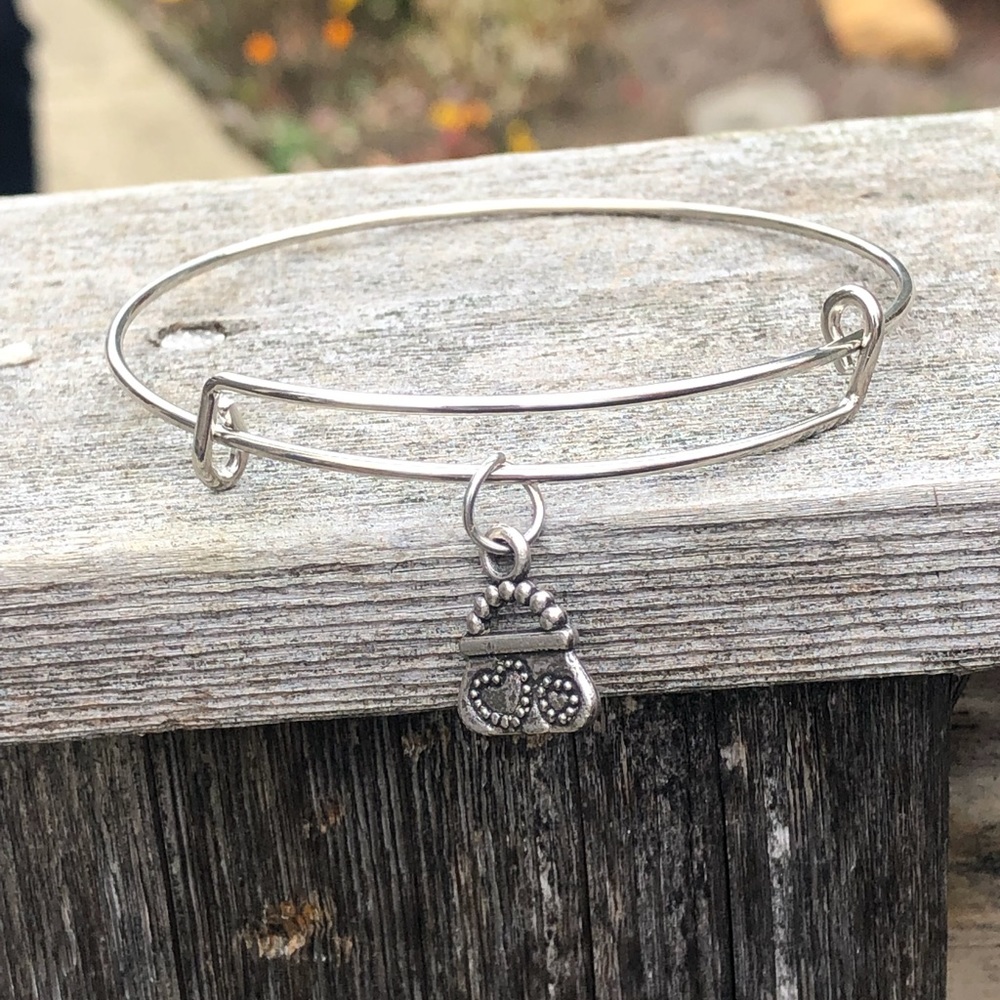 Silver bracelet slips on with a handbag charm